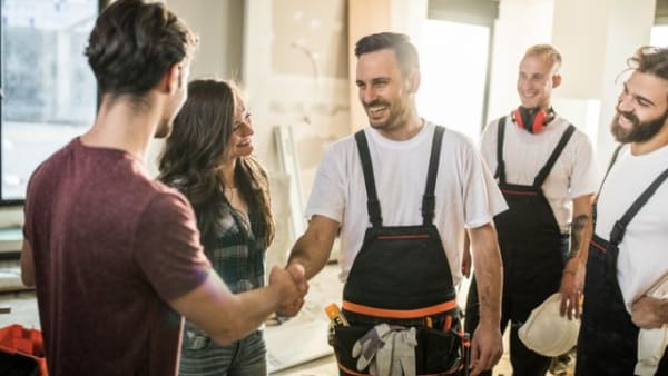 General contactors shaking hands with happy customers