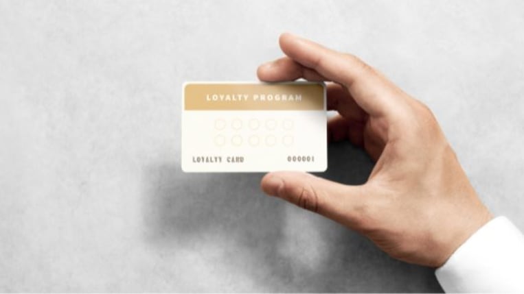 Customer holding a loyalty program card