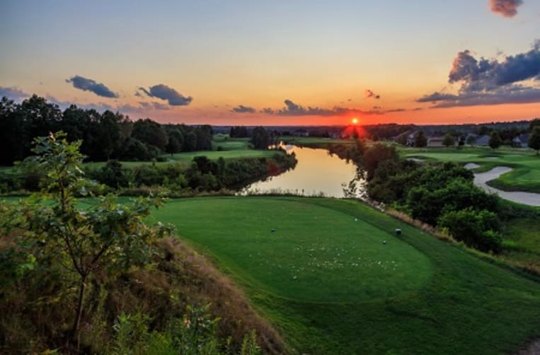 View of the golf course and lake at sunset