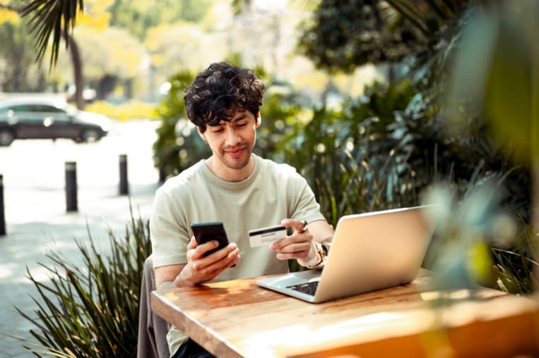 man sitting outside looking at smartphone