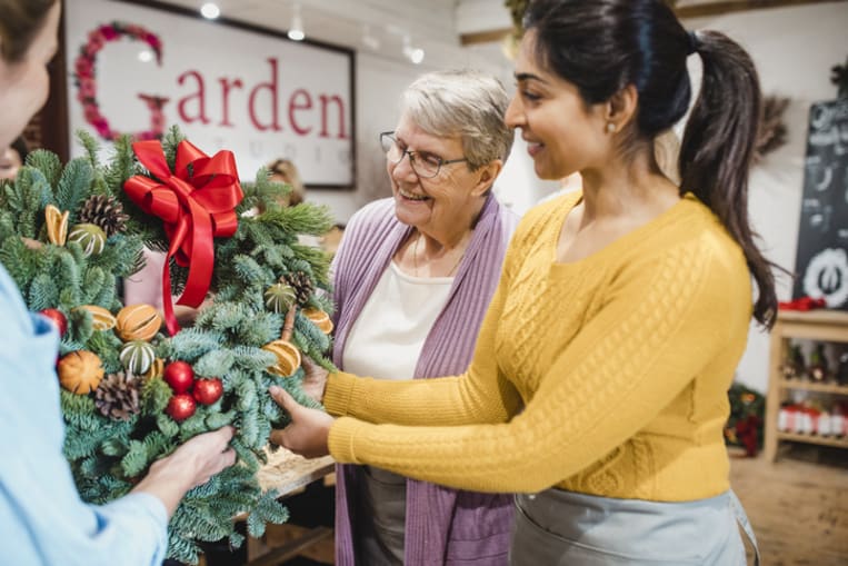 customers shopping for a wreath on small business saturday
