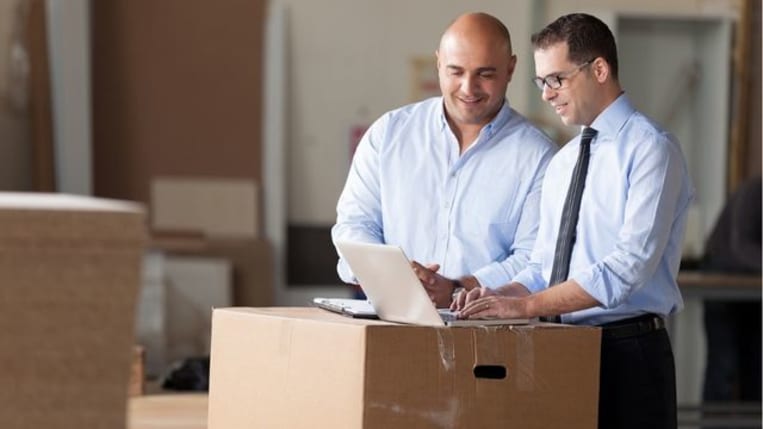 Two businessman working in factory.