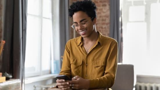 Smiling young African American woman leaving positive review.