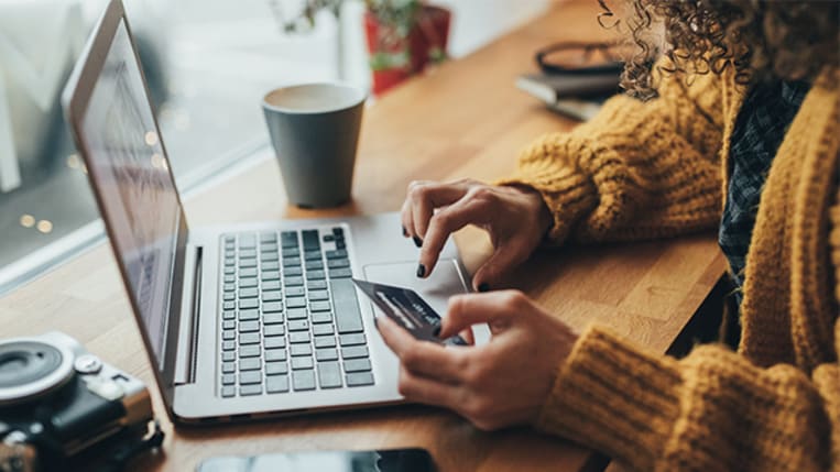 african american woman online shopping with credit card