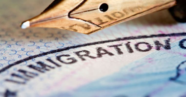 Close up of Immigration on Visa with pen