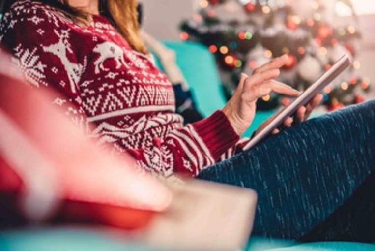 woman sitting on couch with iPad