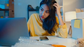 Young Asia businesswoman looks at laptop stressed