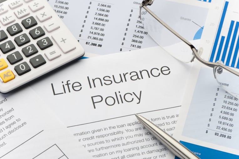 Close up of Life Insurance Policy with pen, calculator 
