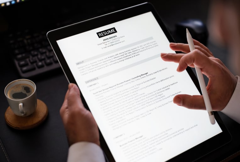 Businessman Reading A Resume On Digital Tablet