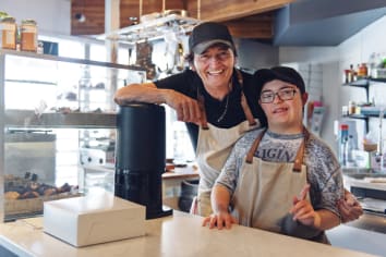 Small business portrait with older man and person with Down Syndrome