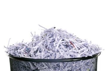 Trash can with shredded papers inside 