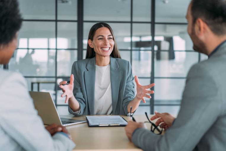 Couple sitting down with a sales agent