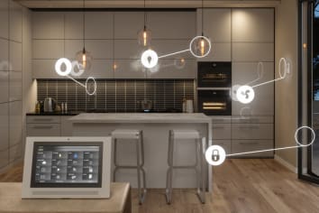 Kitchen with smart home icons appearing on lights, outlets, water, thermostat and refrigerator and tablet in foreground.