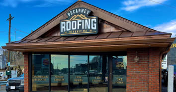 Front of office building of DeCarney Roofing with their branded logo signage