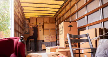 Mover inside moving truck stacking boxes