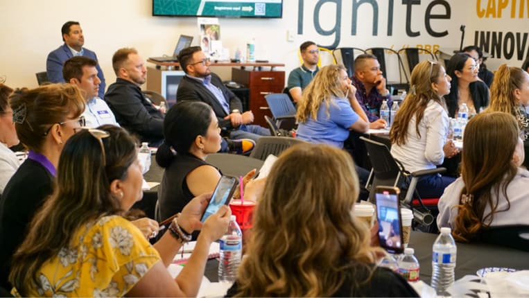 Photo of audience members listening to speaker at conference