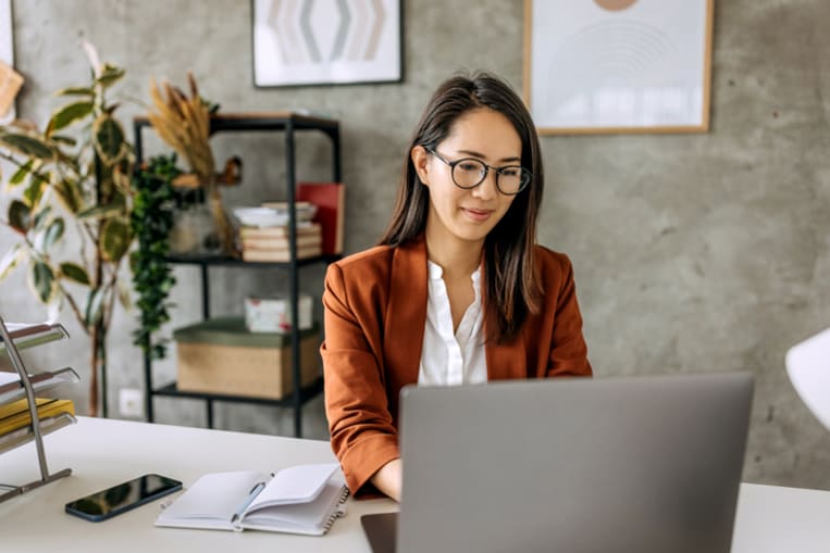 Well dressed beautiful mid adult businesswoman working from home office - stock photo