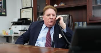 Kevin Seaver of The Law Office of Kevin Seaver answering the phone at this desk