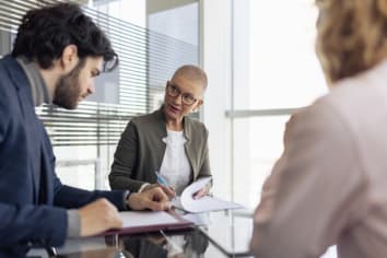 Person helping fill out documents