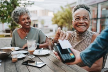 Senior woman making credit card payment
