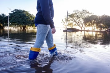 People protected with rubber boots in a flooded environment	
