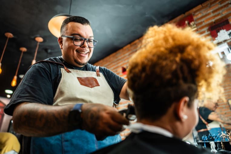 Barber cutting the customer's hair at a barber shop