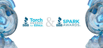 Graphic design featuring the logos of the BBB Torch Awards for Ethics and BBB Spark Awards. The Torch Awards for Ethics logo is on the left in blue and light blue, while the Spark Awards logo is on the right in bold blue. A large gray ampersand (&) separates the two logos. Both logos are surrounded by abstract blue and gray circular paint textures on each side.