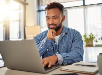 happy businessman working on his laptop at home