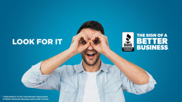 Pic of make with white undershirt and unbuttoned blue button down shirt making a pair of glasses with his hands, with the Sign of A Better Business Logo on the right side. 
