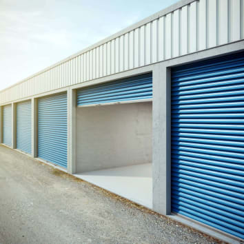 storage unit with blue doors, one of the units is opened showing the inside of the unit
