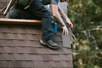 man working on roof