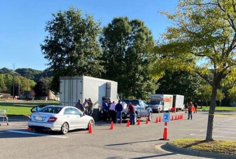 Cars lined up next to shred truck to drop off documents to be shred