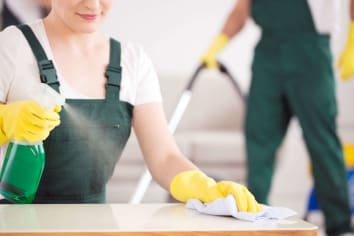 woman and man using cleaning supplies