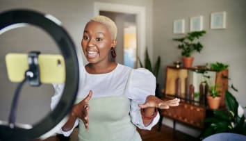 business owner filming video in front of a mirror