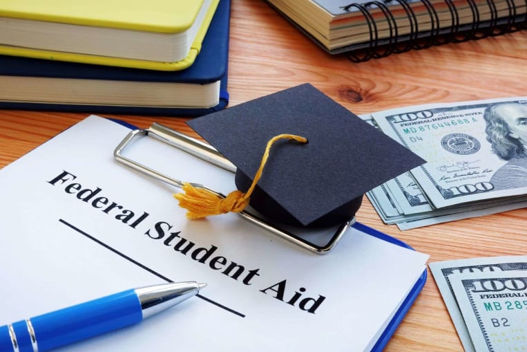 financial aid graduation cap scholarship on table