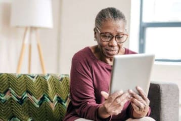 older african american woman looking at tablet