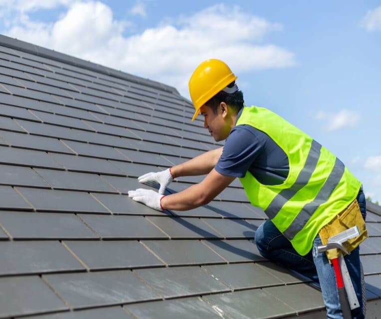 roofing contractor working on roof