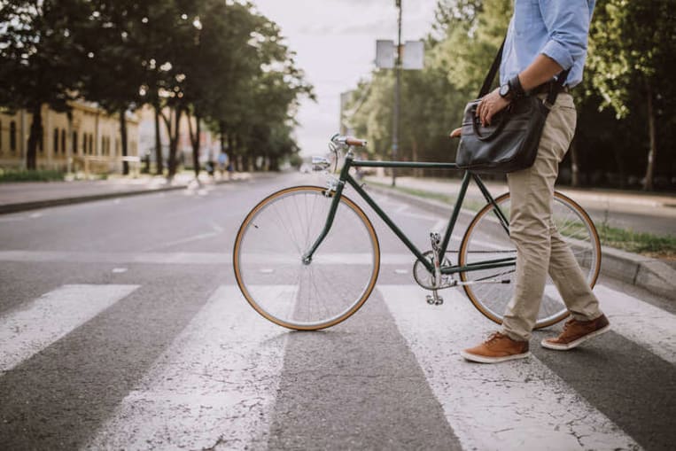 man riding bike in city