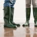 people standing in flooded house with rain boots